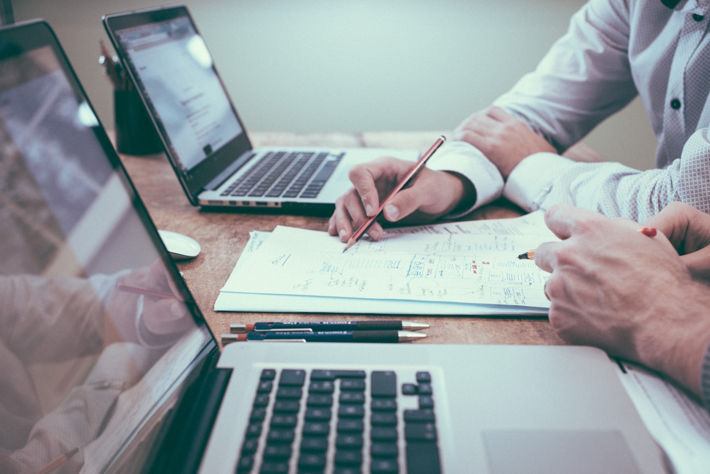 Planning documents and laptop on a desk